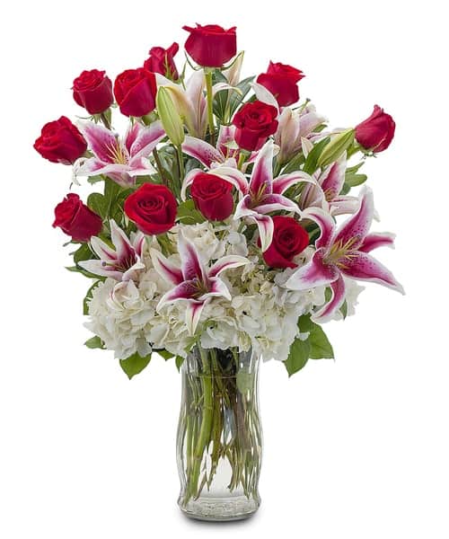 A classically gorgeous arrangement of a dozen red roses, accented with Lilies and Hydrangea to really make an impression.