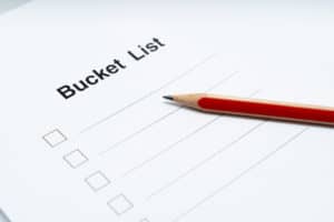White paper bucket list and red pencil