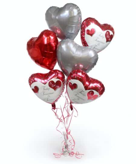 Send your love with our Today, Tomorrow and Forever Balloon Bouquet. Three of our most popular heart shaped balloons with the phrase "Today, Tomorrow & Forever" and "I Love You" are paired with red and silver hearts. A great way to show them that you care for any occasion; Birthday, Anniversary or just a reminder of your love. Tethered with a decorative weight, these balloons are all heart!