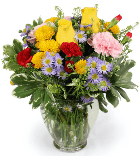 Brighter Days is a bouquet that is sure to bring a smile to their face. An assortment of bright primary colors that include flowers like Roses, Carnations and Chrysanthemums. The size is perfect for a bedside table or desk. Presented in a clear glass vase along with assorted greenery.