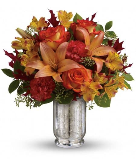 This fall, make that special someone blush with joy! Gorgeous bi-color roses and lilies brighten their day, while the magnificent mercury glass hurricane vase is a sparkling gift they'll always cherish.